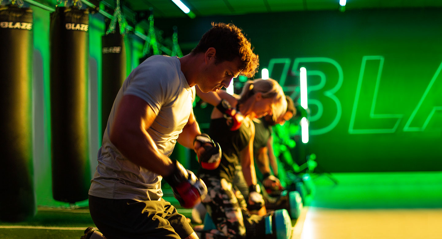 A group of people punching punchbags on the floor as part of Blaze.