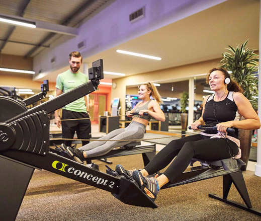Image of women using rowing machines in gym at David Lloyd Clubs